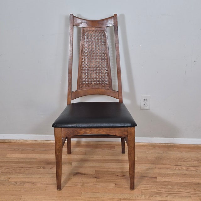 This is a handsome mid century modern chair by Liberty Chair Co. The chair has a solid walnut frame, tapered back with...
