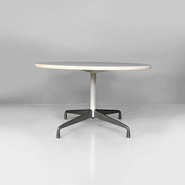 American modern dining table by Charles & Ray Eames for Herman Miller, 1960s Dining table with a round wooden top covered...