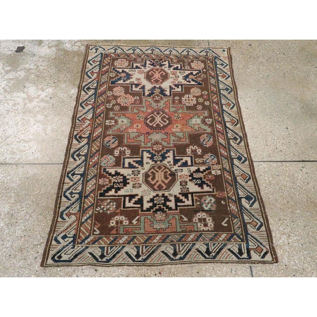 An antique Caucasian Zeychur Kuba throw rug. Three and a fraction eight point geometric ‘Lesghi’ stars in dark blue,...