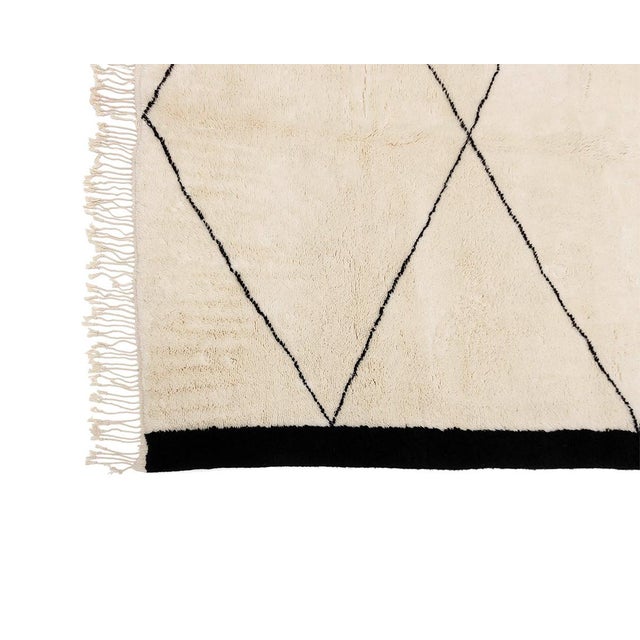 A clean, graphic geometry — a chain of connected diamonds runs down a soft ivory field, framed on either side by bold...