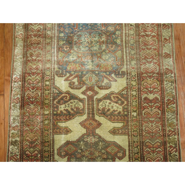 an early 20th century neutral tone Persian Malayer Wide Runner. some animals spotted in the field