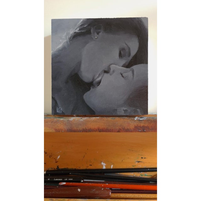 This intimate oil painting captures a moment of closeness between two figures, their lips almost touching in a tender...