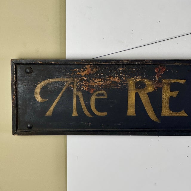 A unique minimalist antique wooden sign that advertises "The Red ★ Laundry". Black painted framed wood with gold lettering...