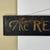 A unique minimalist antique wooden sign that advertises "The Red ★ Laundry". Black painted framed wood with gold lettering...