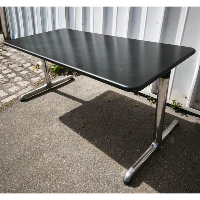 Giancarlo Piretti dining table. Chromed metal legs and black lacquered wood top. The top has minor imperfections. Table...