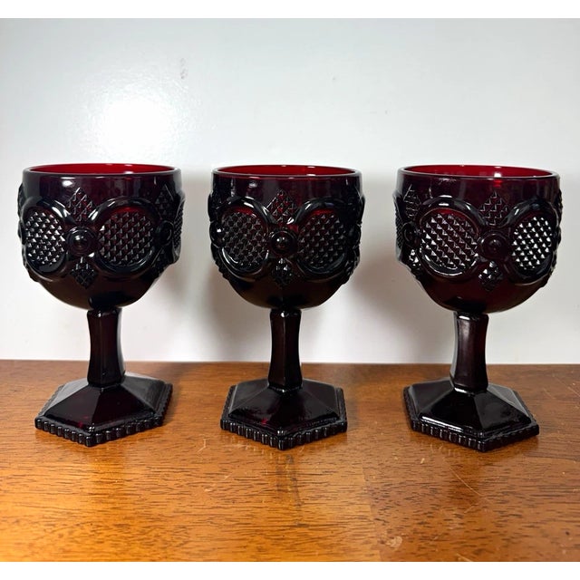 Beautiful vintage set of 3 deep ruby red pressed-glass goblets featuring an ornate raised diamond pattern and faceted...