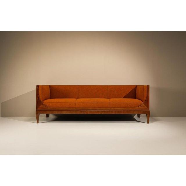 A rare box sofa by Danish cabinetmaker Frits Henningsen, dating from around the 1940s. Its enclosed wooden frame and...