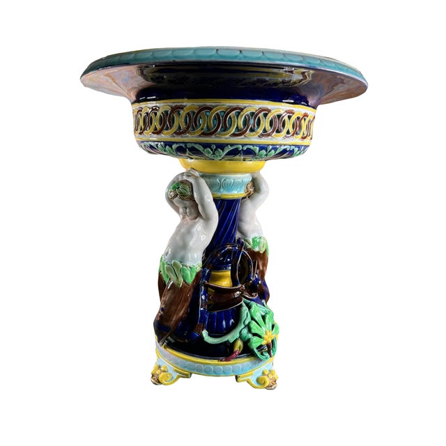Large majolica standing bowl decorated with fantastic creatures on the pedestal. This magnificent centerpiece comes from...