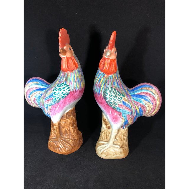 A striking pair of Antique Famille Rose Porcelain Cockerels, each standing approximately 12 inches tall. These hand-...