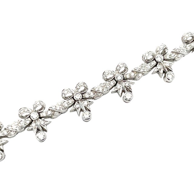 Elegant vintage necklace crafted in solid 18K white gold. Featuring classic bowie-style links set with sparkling diamonds...