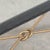 A striking vintage forged iron coffee table combining a sculptural black metal frame with elegant gilt detailing and a...