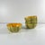 Melon service in earthenware for 4 people, 20th century Comprising one leaf-shaped platter and four half-melon-shaped...