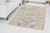 This is a vintage Turkish Oushak rug from the Mid 20th Century. The piece was hand-knotted.