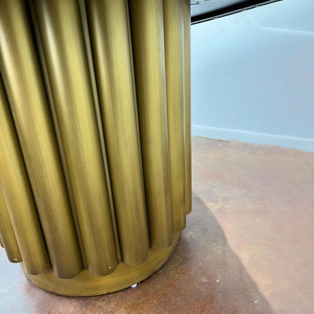 Art Deco style round dining table. Finished in antique brass and black, its versatile 55? diameter size makes it great for...