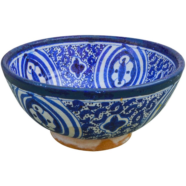 Handcrafted ceramic bowl from Fez, Morocco hand-painted with a Moorish pattern in blue. No maker's mark. Two holes on...