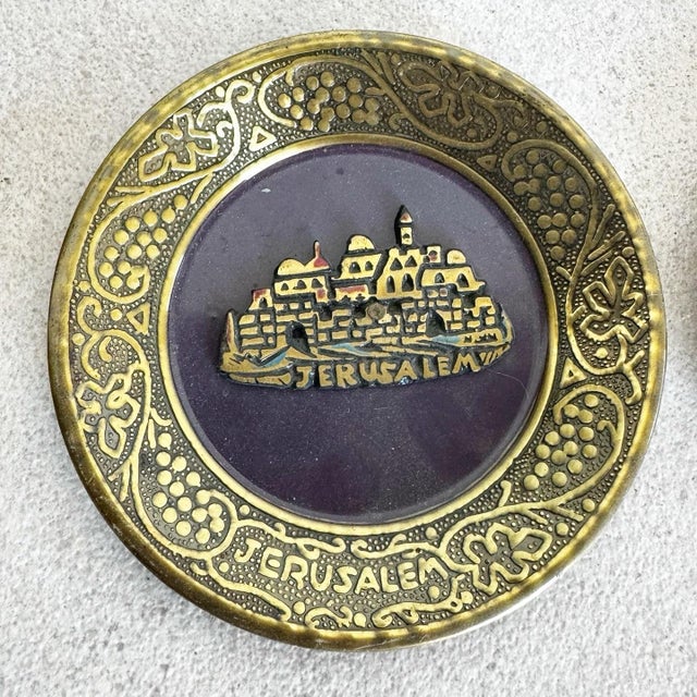 This set of two vintage Israeli brass enameled decorative plates features stunning depictions of Jerusalem and the...