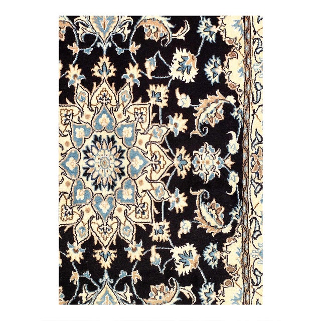 Persian Nain rugs are renowned for their detail and fine use of outlining along the central motifs. Breaking from the...