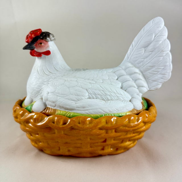 A Staffordshire pottery hen on a basket covered tureen, England, circa 1890 The hand painted bisque hen sits on her eggs...