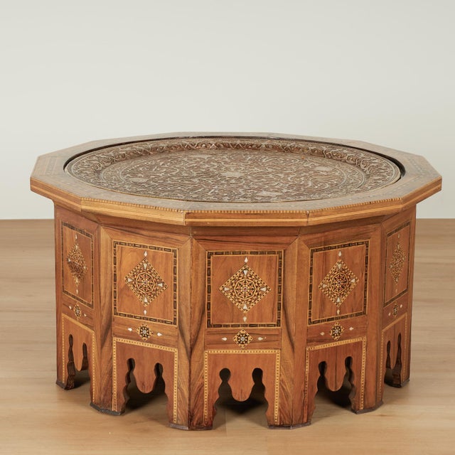 Impressive antique Moroccan table crafted in mahogany featuring a removable silvered brass tray hand hammered in symbolic...