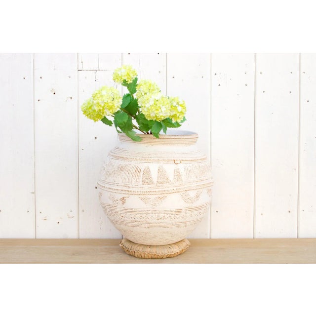 An original Nupe clay pot from Nigeria. This beautiful tribal African Terracotta pot of spherical shape has a custom...