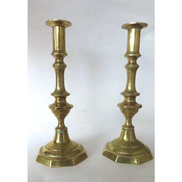 Pair 19th century English brass candlestick holder. Octagon base. Beaded edge. Measures 10” tall. Good condition.