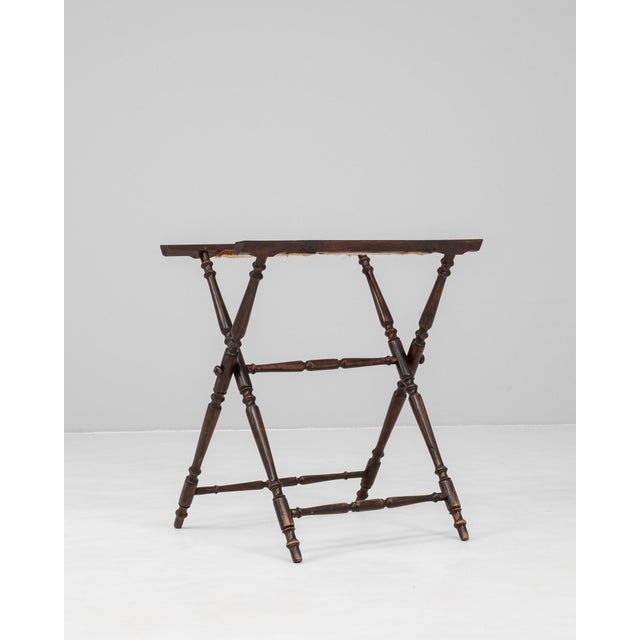 This 1900s French butler tray stand showcases elegant turned wood craftsmanship with a classic folding X-frame design. The...