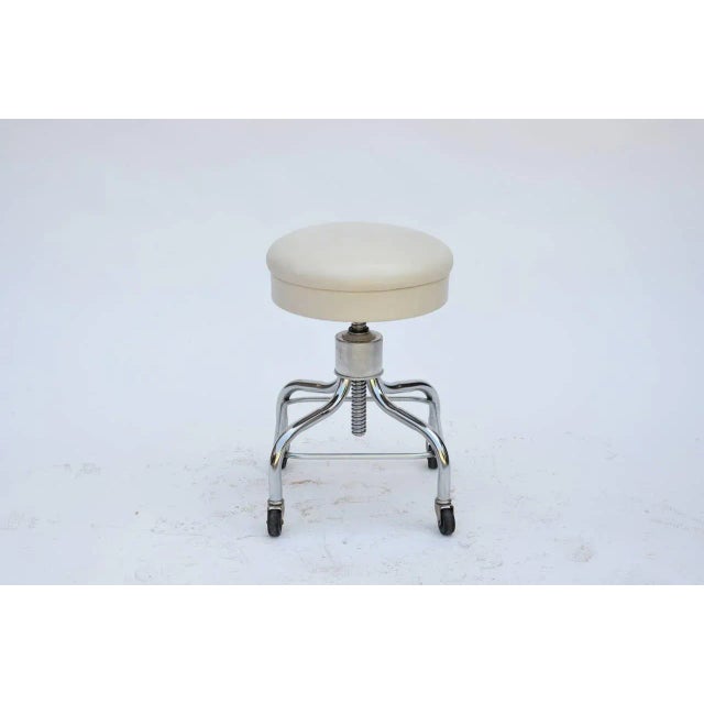 Set of 4 vintage chrome and white leather adjustable rolling stools. Heavy, sturdy and fully functional. Great for an...