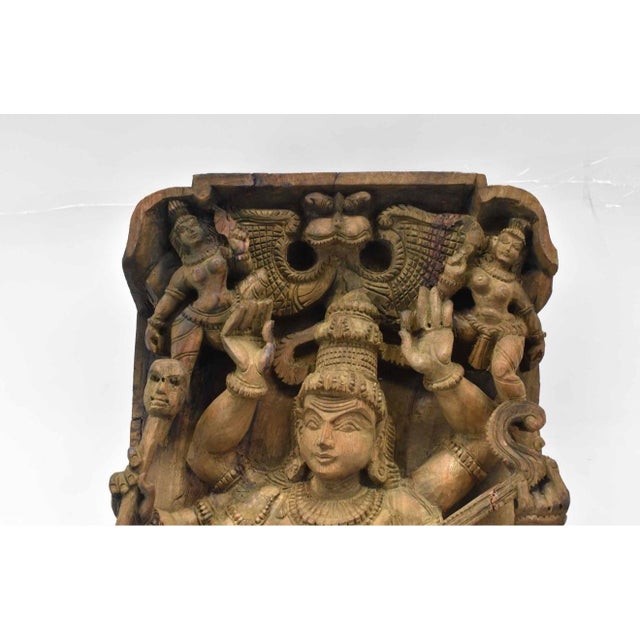 An impressive Indian hand-carved wooden relief panel depicting Saraswati, Hindu goddess of knowledge, music and the arts....