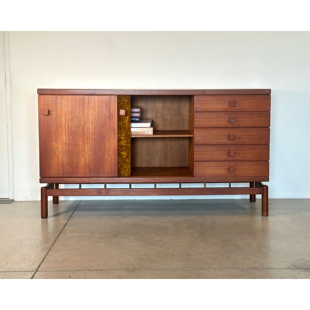 Sideboard by Ilmari Tapiovaara, made in Italy by Permanente Mobili Cantù in the 1950s. Made of teak wood, with brass and...