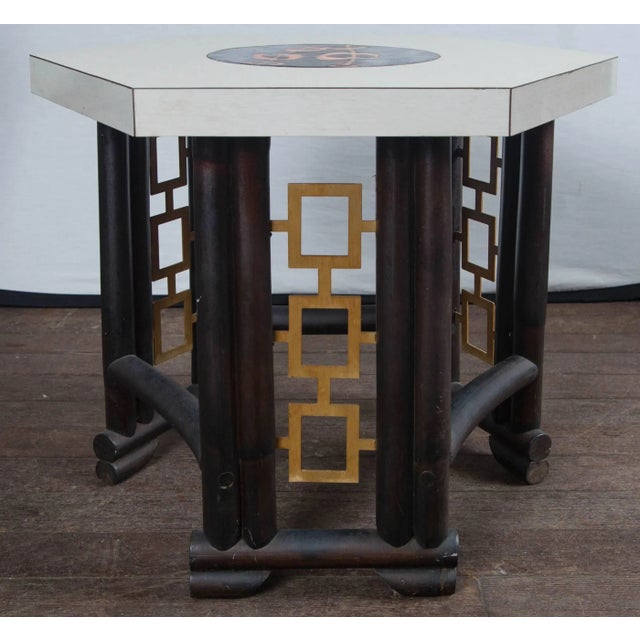Custom-made Asian, bamboo style wood table, laminate top with inlaid round enameled piece in center. Geometric gilt metal...