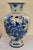 Mid-Century Hand-Painted Delft Vase This elegant Delft vase stands out with its rich cobalt floral motif, delicately hand-...
