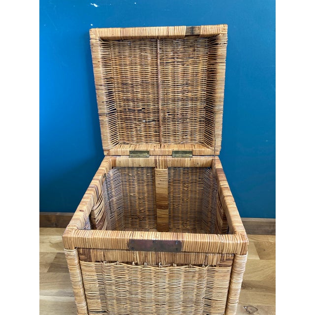 Boho chic wicker trunk with brass closure. The frame is solid wood wrapped in wicker. It opens from the top and front.
