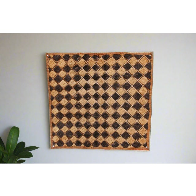 A captivating masterpiece of African textile art, this vintage Kuba cloth panel is a testament to the unparalleled...