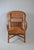 This elegant armchair combines traditional craftsmanship with a distinctive and highly decorative silhouette. Entirely...