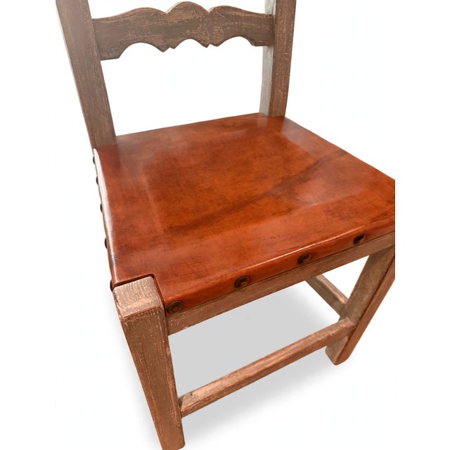 A handsome set of eight Spanish Colonial Revival dining side chairs, each with a ladder back of three hand-carved...
