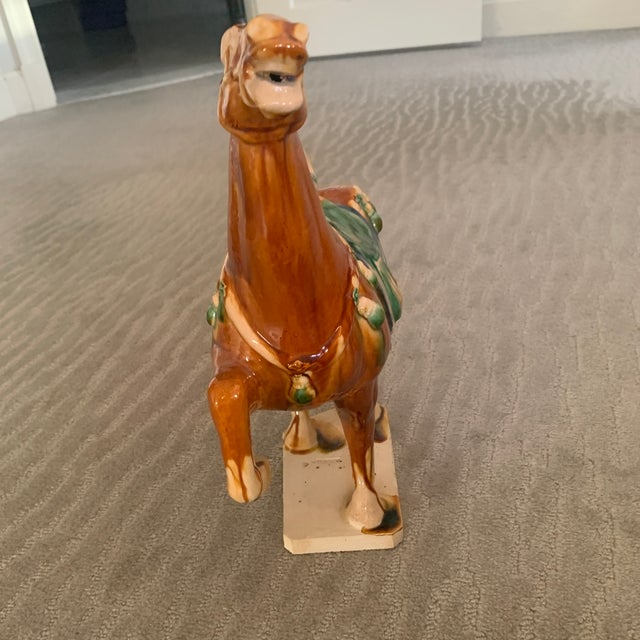 This horse is in lovely condition with vibrant tan, beige and cream coloring and rich blue and green accents. It Stan’s on...