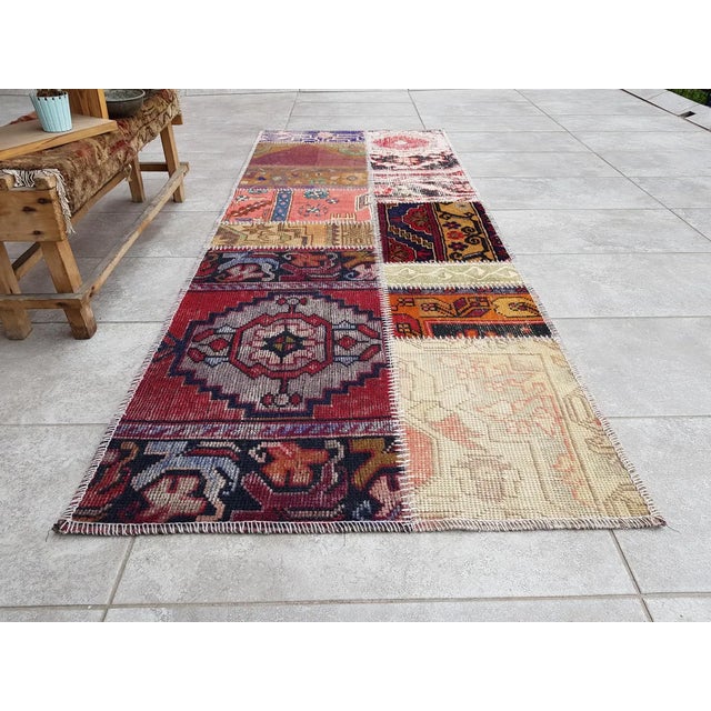 This is a vintage Turkish Oushak rug from the Mid 20th Century. The piece was hand-knotted.