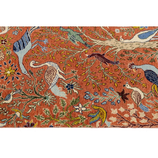 This stunning modern Indian wool rug features a whimsical "Paradise Garden" design, hand-knotted to add warmth and...