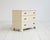 Three-drawer ivory-lacquered chest of drawers with metal and Bakelite handles. Scandinavian production from the 1930s and...