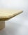 Elegant vintage coffee table from the 1970s, in solid vanilla-colored travertine. The sculptural design features a...
