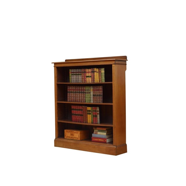 K0622 edwardian open bookcase in walnut, having shaped upstand to the back edge, figured walnut top with moulded edge and...