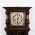 Antique oak wall clock with carved details from the 1920s. Classic wooden wall clock with decorative craftsmanship. —...