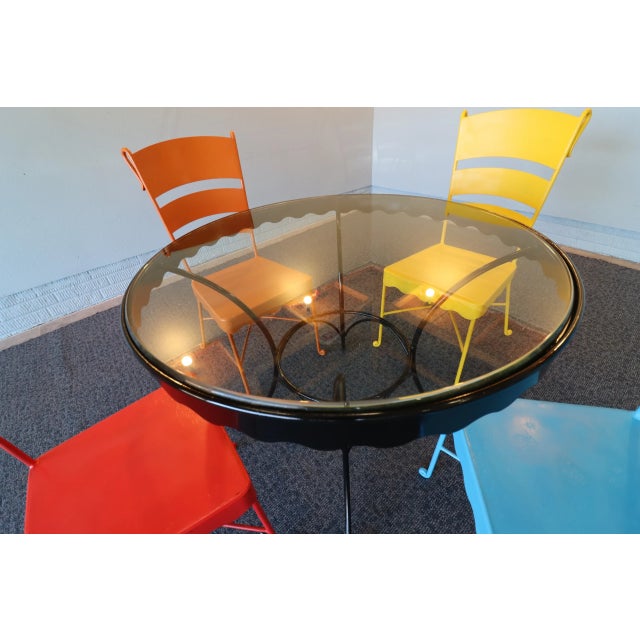 A striking and substantial mid-century modern outdoor bistro set dating to the 1950s–1960s. This set features four heavy-...
