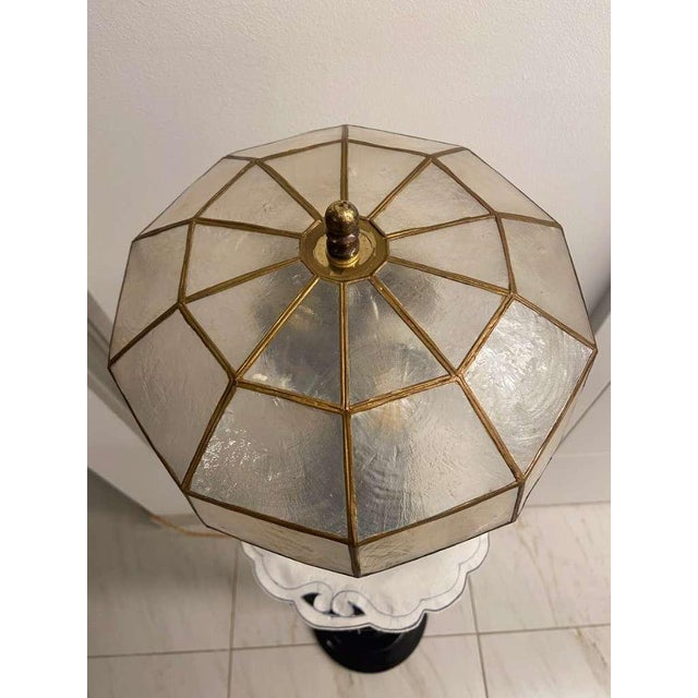 Striking pair of table lamps with large, faceted polygonal shades composed of translucent panels set within a geometric...