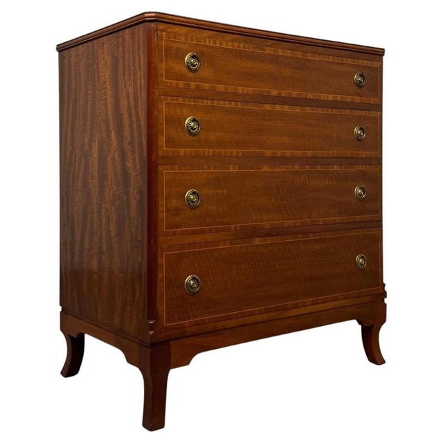A beautifully crafted early 20th-century English chest of drawers, finely constructed in mahogany and distinguished by...