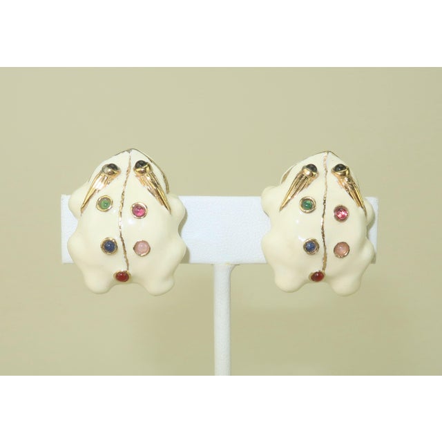 Jump for joy over a precious pair of Judith Leiber enamel frog clip-on earrings. The gold plated earrings are decorated...