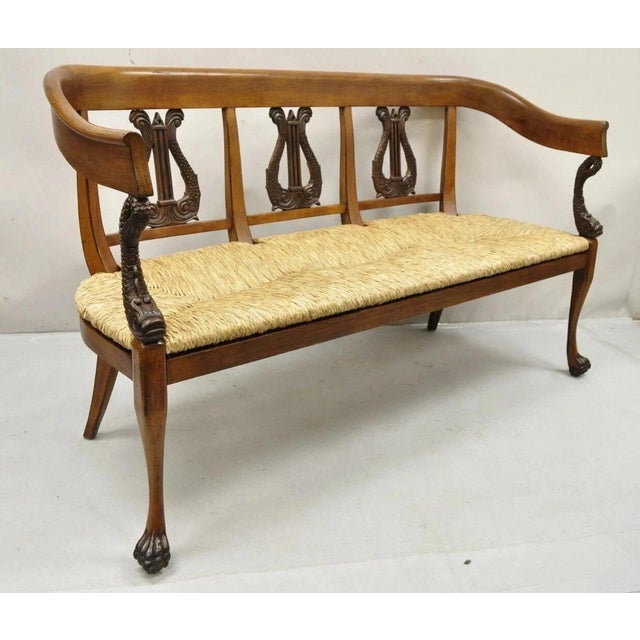 Vintage Italian Neoclassical Cherry Wood Dolphin Lyre Carved Rush Seat Bench. Item features solid carved wood frame,...