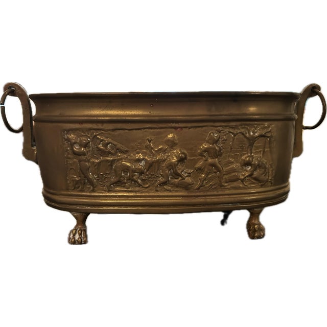 Antique French Brass Jardiniere Planter. Oval with lion feet and round handles. Features French repossessed scene of farm...