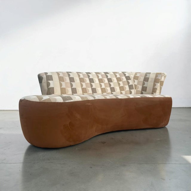 Vintage 1980s sculptural kidney-form sofa with a dramatic curved silhouette and low, fully upholstered base. The seat and...