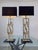 An imposing pair of brass and marble table lamps. Each lamp features an elegant and slender rectangular frame in gilded...